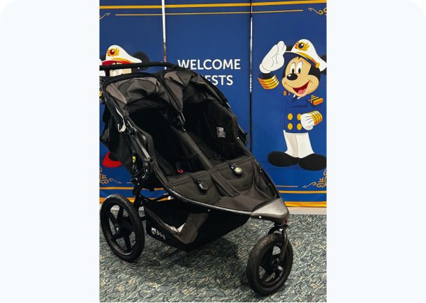 Double stroller in front of cartoon backdrop.